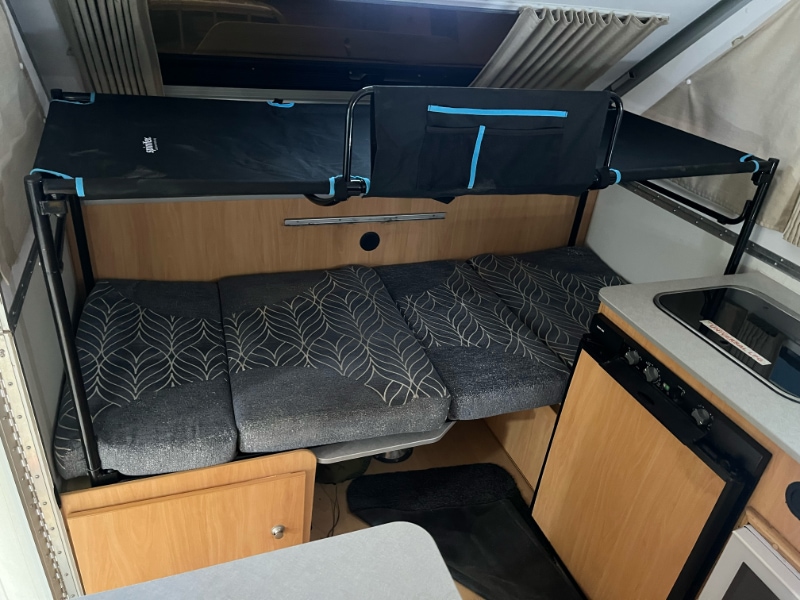 Spinifex bunk fitted over the bench bed in a 1D Avan Cruiseliner