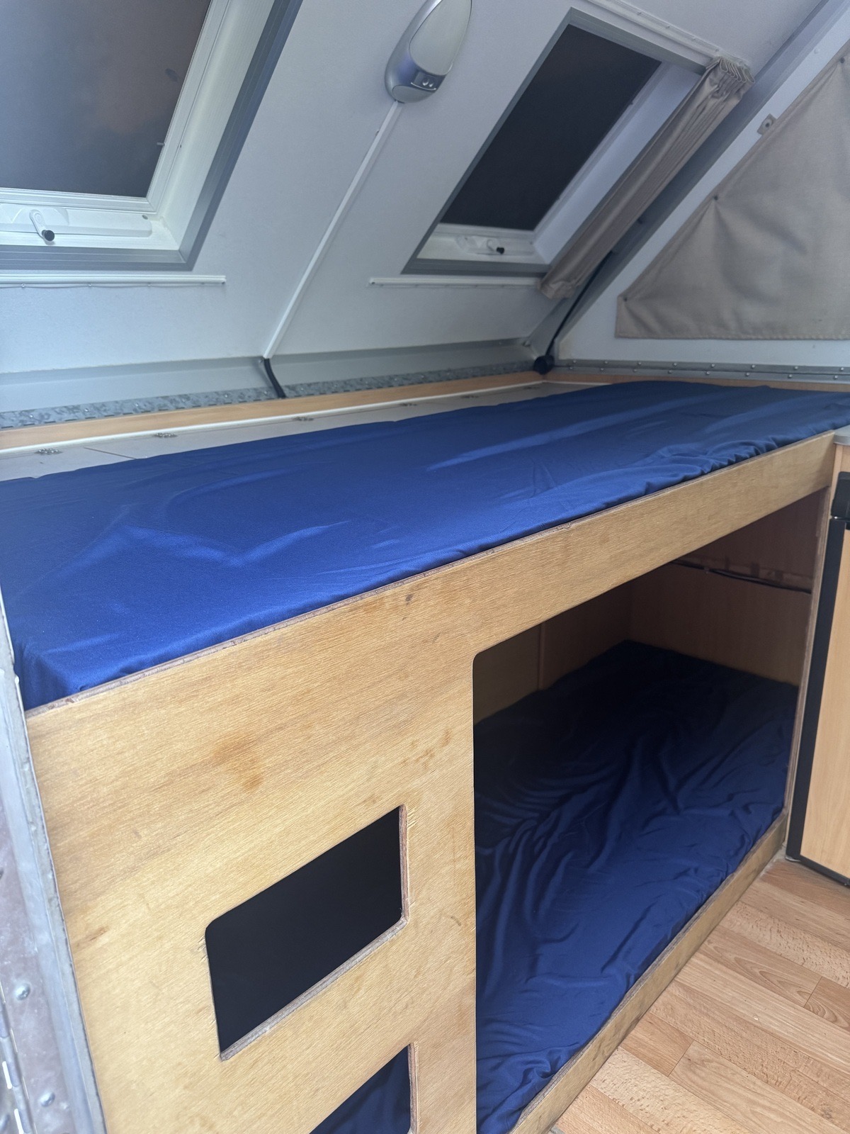 Factory built-in timber over-under bunk beds with blue mattresses