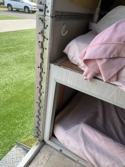 Factory built-in over-under bunks seen through the open door of an Avan from outside