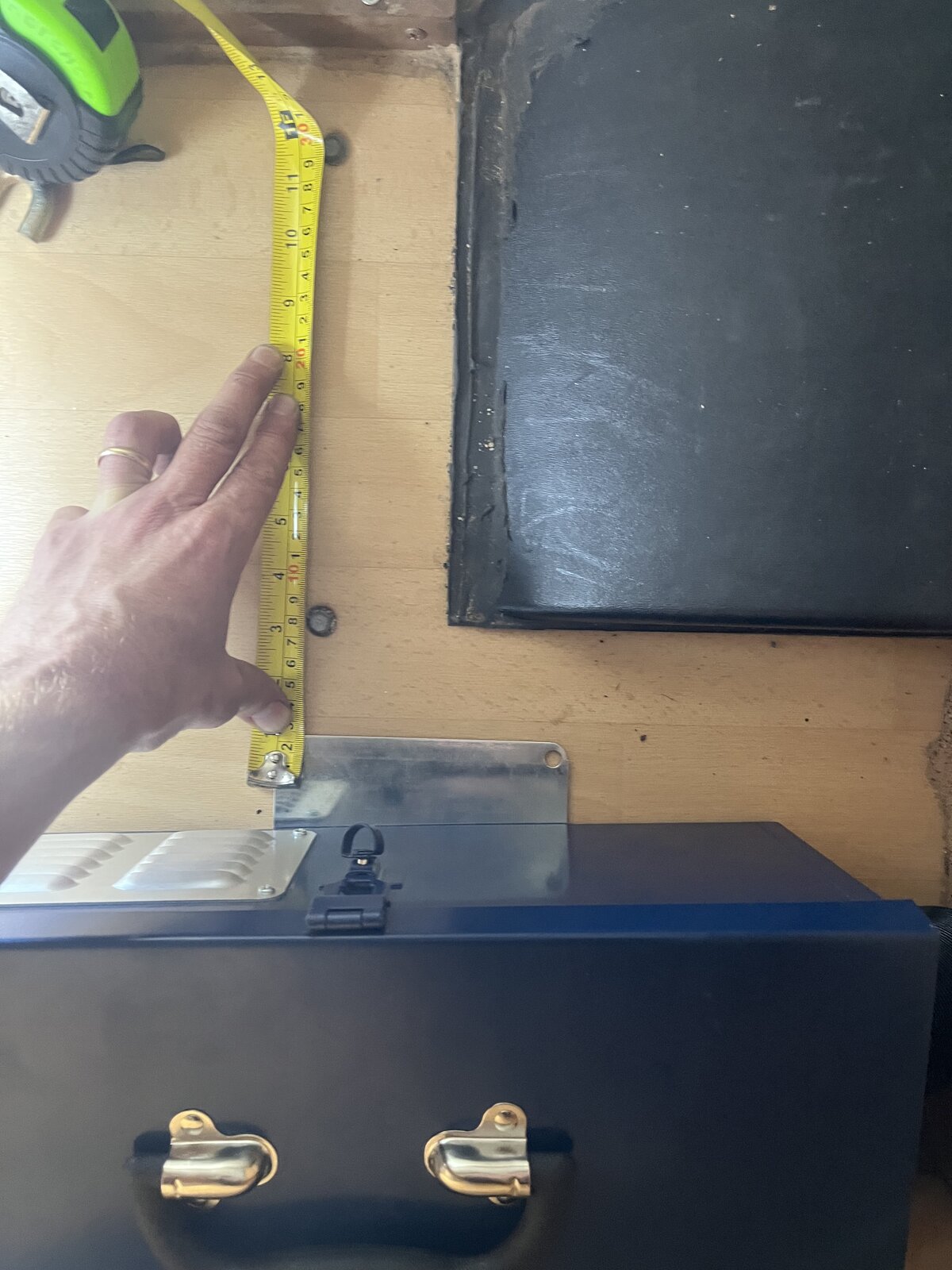 Measuring clearance above storage box in caravan interior