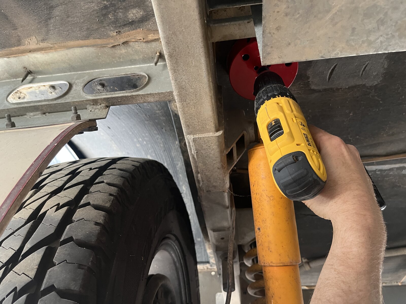 Drilling hole through caravan chassis underside with DeWalt hole saw