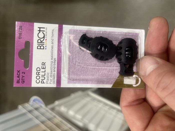 Birch black plastic cord pullers in their packaging, a two-pack from a sewing shop