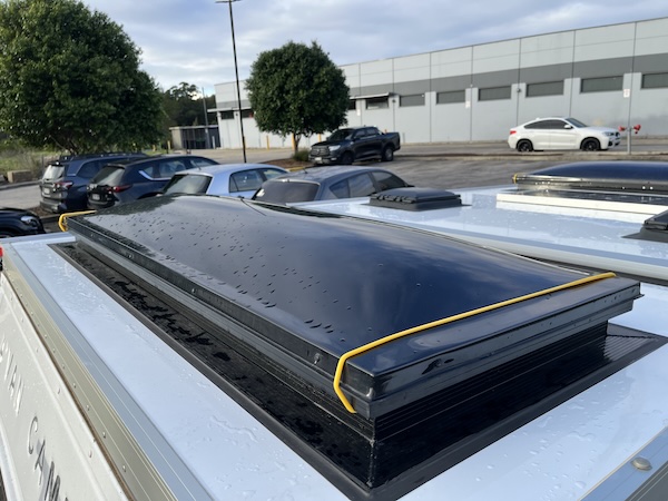 Grunt Flexband strap holding down a wind-out dome window on an Avan roof