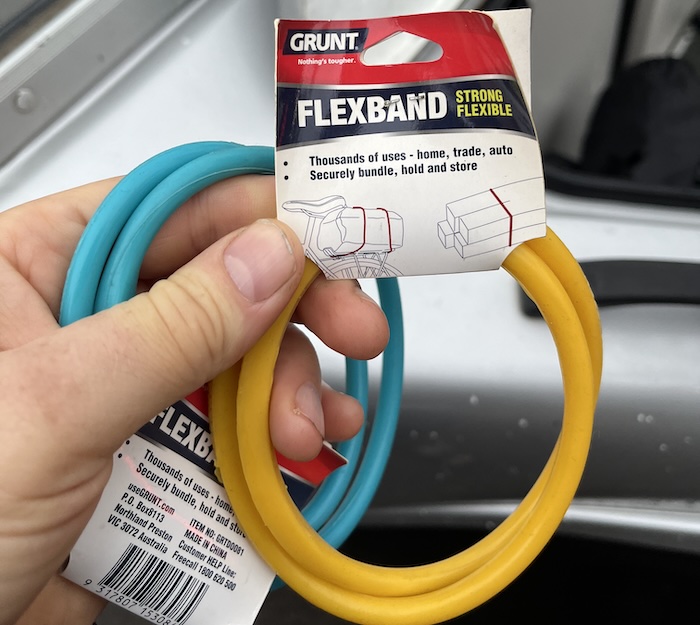 Two Grunt Flexband rubber straps in blue and yellow, still in their Bunnings packaging