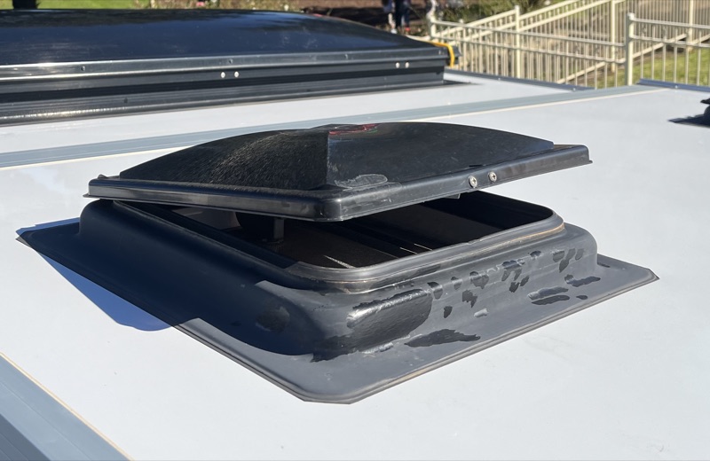Avan vent lid popped open on the roof, lifted off its base the way it does at freeway speed
