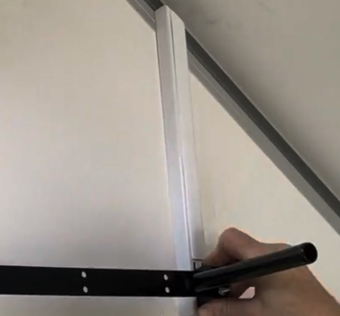 White Flexi Storage strip cover snapped over the wall strip, blending it into the apex wall as clean white trim
