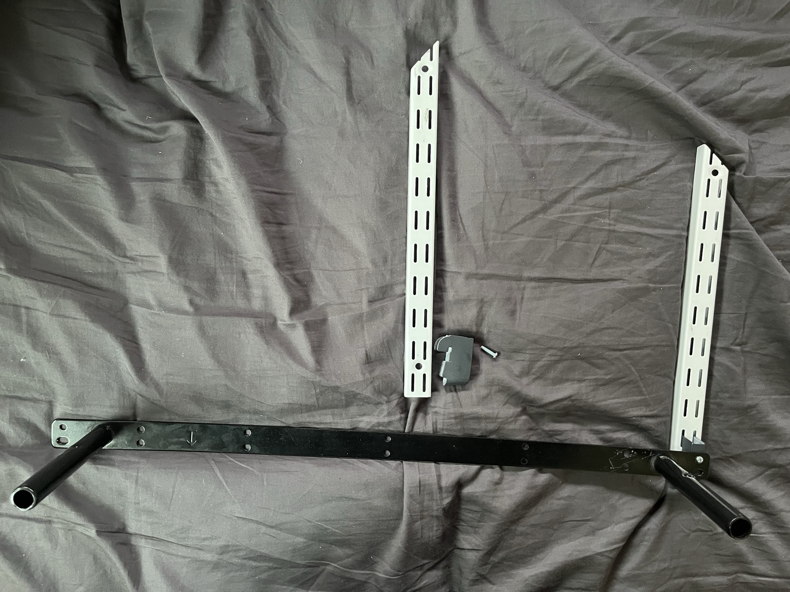 Flexi Storage wall strips, shelf bracket and the black floating shelf mounting bar laid out to measure