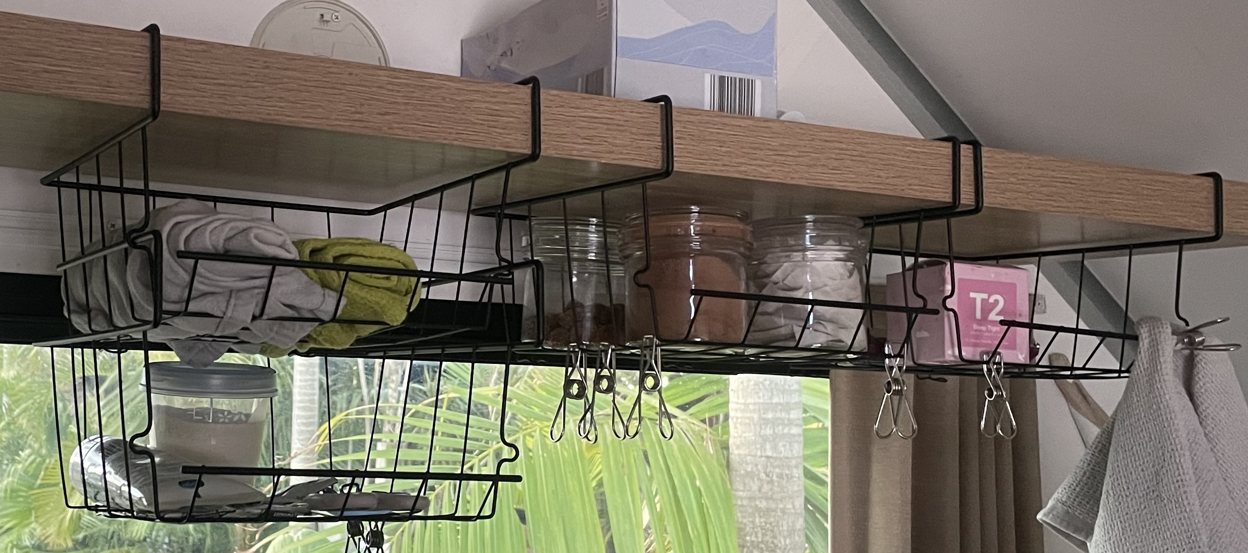 Stackable wire under-shelf baskets from Temu clipped onto the 36mm oak floating shelf